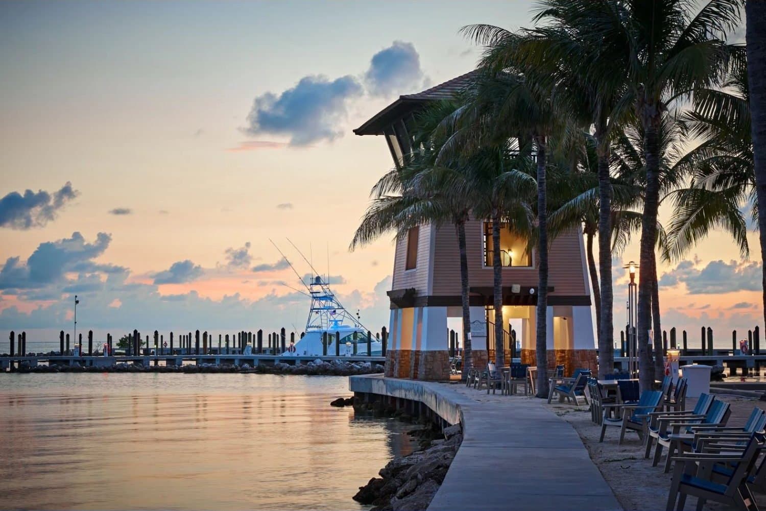 Sportfishing boat docked at dusk beside the Marlin Bay observation tower